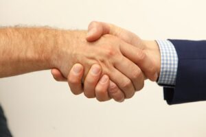 Person shaking hands with car accident lawyer