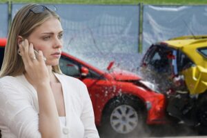 Woman on phone after car crash with her car accident attorney from Maida Law Firm