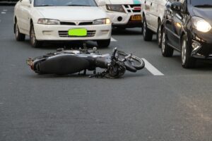 Motorcycle in road after an accident where they will need to hire an auto accident lawyer. 