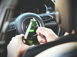 Driver opening alcohol in car before crash where victim needs an accident attorney to get compensation