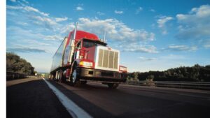 Red semi truck on highway after accident managed by truck accident lawyer