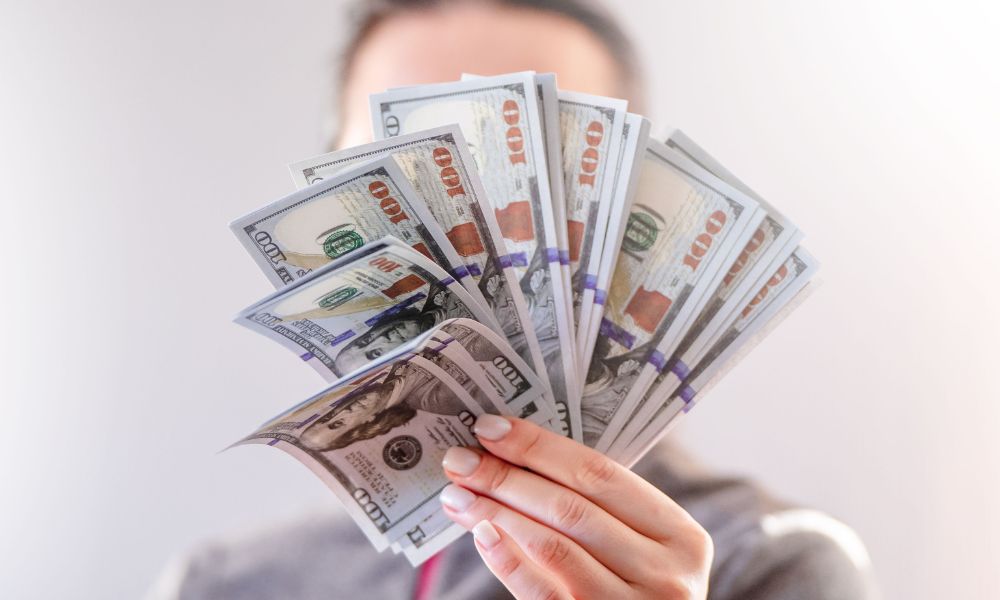 person holding money after accident payout advised by Houston car accident attorney