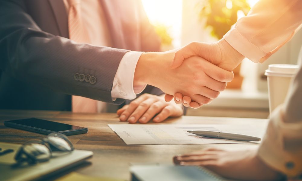 client shaking hands with trusted Houston car accident attorney