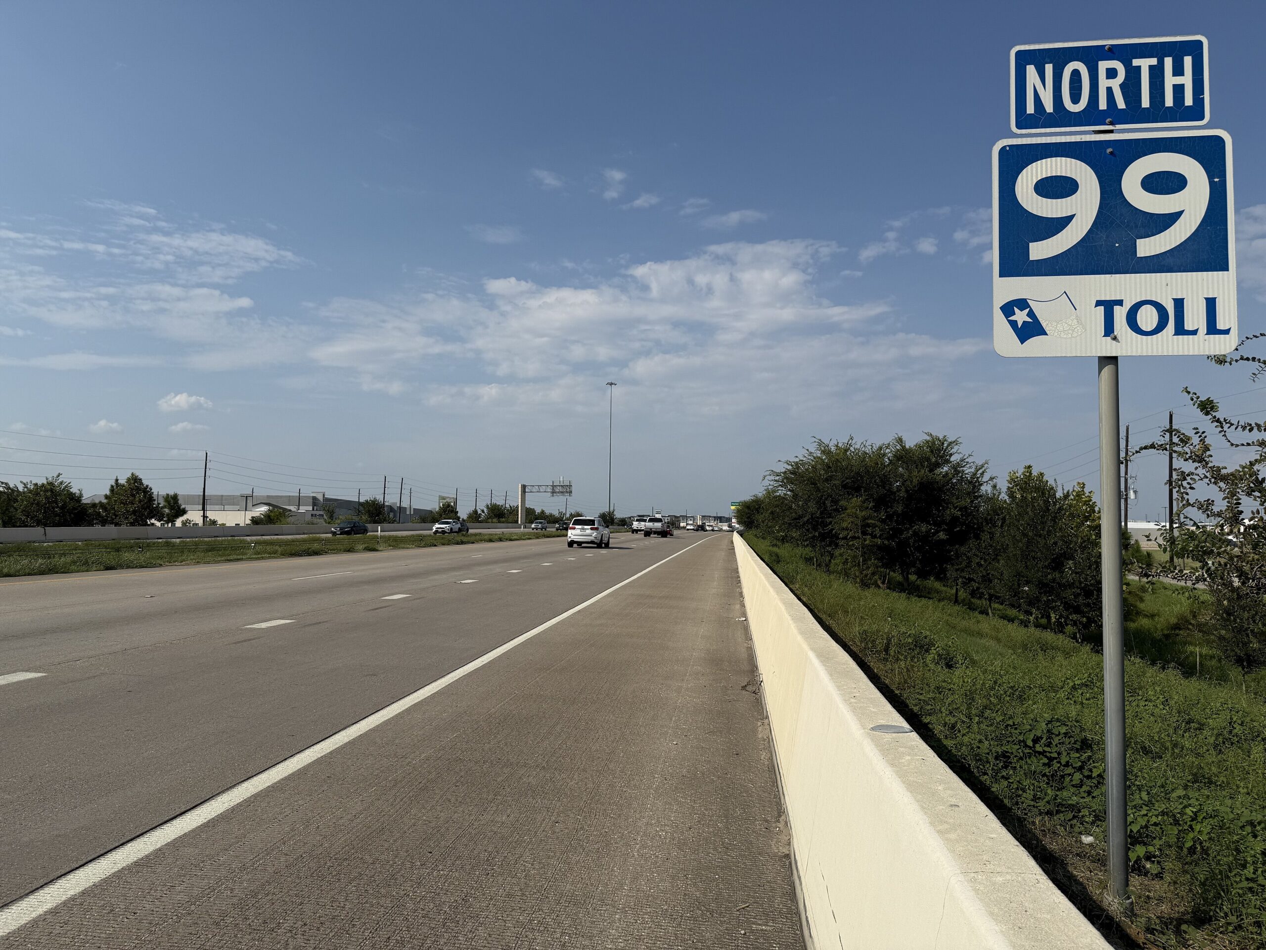 Northbound Grand Parkway (SH-99) toll road just north of its interchange with the I-10 Katy Freeway in west Harris County, Texas, September 14, 2025, with a SH-99 Toll sign and concrete pavement