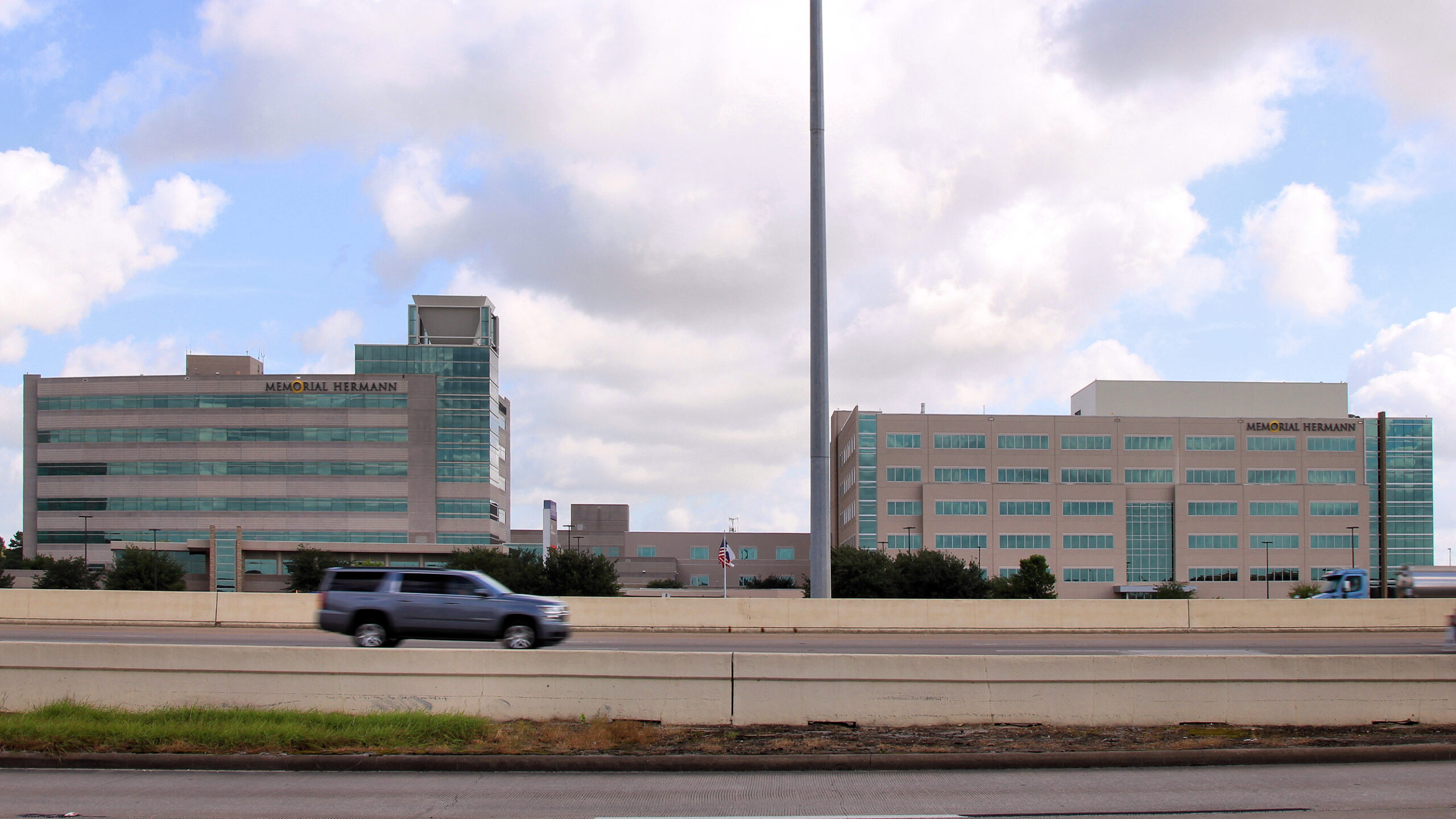 Memorial Hermann Katy Hospital, 23900 Katy Fwy, Katy, Texas, seen across the I-10 Katy Freeway main lanes and concrete barrier, July 17, 2019